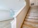 Staircase with stone risers adjacent to a living room and front window at 11291 Cay Spruce Way, San Antonio, FL 33576