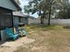 Expansive backyard with lush greenery, a privacy fence, and outdoor seating for entertainment at 11807 Addison St, Spring Hill, FL 34609
