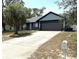 Charming single-Gathering home featuring a spacious driveway and a well-maintained front yard with mature trees at 11807 Addison St, Spring Hill, FL 34609