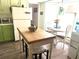 Cozy eat-in kitchen with a breakfast table, white appliances, and a refrigerator, offering a welcoming space at 11807 Addison St, Spring Hill, FL 34609