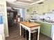 Well-designed kitchen with green cabinets and an island, seamlessly connecting to the living area at 11807 Addison St, Spring Hill, FL 34609