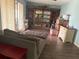 Inviting living room featuring wood floors, a large entertainment center, and ample storage at 11807 Addison St, Spring Hill, FL 34609