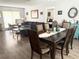 Open-concept living area with wood floors, a dining table, and a comfortable sectional, perfect for entertaining at 11807 Addison St, Spring Hill, FL 34609