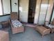 Relaxing wicker patio furniture creates a cozy and inviting outdoor living space with a sliding glass door at 11807 Addison St, Spring Hill, FL 34609