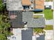Aerial view of rooftops showing a mixture of textures, including shingles, flat roofs, and green spaces between properties at 12516 Cobble Stone Dr, Hudson, FL 34667