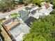 Aerial view of townhouses with diverse roof types, lush trees, and glimpses of neighborhood streets, creating a harmonious community setting at 12516 Cobble Stone Dr, Hudson, FL 34667