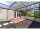Back patio featuring a pergola, tile section, and mulch bed for low-maintenance appeal at 12516 Cobble Stone Dr, Hudson, FL 34667