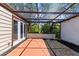 This back patio features a pergola with a tile section surrounded by a mulch bed at 12516 Cobble Stone Dr, Hudson, FL 34667