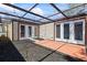 Back patio with two sets of french doors and a pergola for a backyard retreat at 12516 Cobble Stone Dr, Hudson, FL 34667