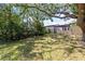 Spacious backyard featuring large trees and green grass for a peaceful view at 12516 Cobble Stone Dr, Hudson, FL 34667