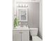 This bathroom features a bright vanity and a framed mirror with decorative lighting at 12516 Cobble Stone Dr, Hudson, FL 34667