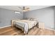 Bedroom features wood floors, ceiling fan and natural light, with a neutral palette at 12516 Cobble Stone Dr, Hudson, FL 34667