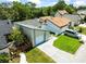 A charming tan home with a gray roof, lush lawn, and a silver van parked in the driveway on a sunny day at 12516 Cobble Stone Dr, Hudson, FL 34667