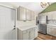 Bright kitchen with stainless steel refrigerator, white countertops, updated cabinets, and wooden floors at 12516 Cobble Stone Dr, Hudson, FL 34667