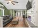 Open-concept living room with modern fireplace, hardwood floors, and ample natural light at 12516 Cobble Stone Dr, Hudson, FL 34667