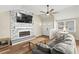 Inviting living area showcases stylish fireplace, ceiling fan and comfortable seating at 12516 Cobble Stone Dr, Hudson, FL 34667