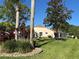 Spacious backyard with lush lawn, mature trees and a screened-in patio at 13339 Amberwood St, Hudson, FL 34669
