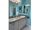 Bathroom featuring double vanity, ample lighting, and a serene atmosphere at 13339 Amberwood St, Hudson, FL 34669