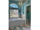 Bright bathroom featuring a soaking tub and large window for natural light and garden views at 13339 Amberwood St, Hudson, FL 34669