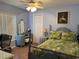 Cozy bedroom with blue accents, a decorative vanity, and floral bedding at 13339 Amberwood St, Hudson, FL 34669