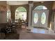 Formal dining room with large windows, chandelier, and a view of the double door entry at 13339 Amberwood St, Hudson, FL 34669