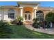 Charming home entrance with double doors, columns, arched entry and lush landscaping at 13339 Amberwood St, Hudson, FL 34669