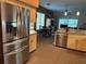 Bright and spacious kitchen featuring stainless steel appliances and an open layout flowing into the dining area at 13339 Amberwood St, Hudson, FL 34669