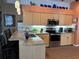 Bright kitchen with a breakfast bar, granite countertops, and modern stainless-steel appliances at 13339 Amberwood St, Hudson, FL 34669