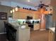Well-appointed kitchen with a breakfast bar, granite countertops, and ample cabinet space for storage at 13339 Amberwood St, Hudson, FL 34669