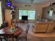 Open concept space with living room and dining area, featuring a large window and comfortable seating at 13339 Amberwood St, Hudson, FL 34669