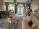 Inviting living room with elegant decor, featuring a marble coffee table and views into the dining room at 13339 Amberwood St, Hudson, FL 34669