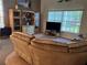Comfortable living room featuring a large sectional couch and natural light from a large window at 13339 Amberwood St, Hudson, FL 34669