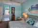 Serene main bedroom with blue accents, leading into ensuite with tub and beautiful backyard view at 13339 Amberwood St, Hudson, FL 34669