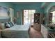 Comfortable main bedroom with large window and view of pool and outdoor living space at 13339 Amberwood St, Hudson, FL 34669
