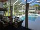 Relaxing screened patio with a dining set overlooking the inviting pool area at 13339 Amberwood St, Hudson, FL 34669