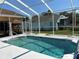 Backyard screened-in pool provides hours of entertainment with room for lounging at 13339 Amberwood St, Hudson, FL 34669