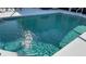 Refreshing in-ground pool with shimmering blue water and a tiled edge at 13339 Amberwood St, Hudson, FL 34669
