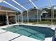 Screened-in backyard pool offers a relaxing retreat for swimming and outdoor enjoyment at 13339 Amberwood St, Hudson, FL 34669