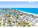Breathtaking aerial view of a coastal town with turquoise waters and vibrant architecture on a sunny day at 13500 Gulf Blvd # 506, Madeira Beach, FL 33708