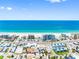 Picturesque aerial view of a beachfront town with beautiful beaches and turquoise water on a sunny day at 13500 Gulf Blvd # 506, Madeira Beach, FL 33708