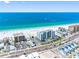 Scenic aerial shot of a condo building by the ocean, adjacent to a commercial street with car parking at 13500 Gulf Blvd # 506, Madeira Beach, FL 33708