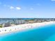 Picturesque beach scene featuring white sand, turquoise water, and coastal buildings at 13500 Gulf Blvd # 506, Madeira Beach, FL 33708