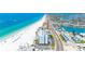 Aerial view showcasing a condo building close to a beach with aqua blue water, near city streets at 13500 Gulf Blvd # 506, Madeira Beach, FL 33708