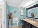 A charming bathroom features a granite countertop vanity, cabinet storage, and stylish wall decor at 13500 Gulf Blvd # 506, Madeira Beach, FL 33708