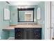 A bathroom showcases a black-trimmed mirror and vanity with extra counterspace and under-cabinet storage at 13500 Gulf Blvd # 506, Madeira Beach, FL 33708
