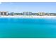 Expansive view of the beach with multiple condo buildings and light blue ocean views on the horizon at 13500 Gulf Blvd # 506, Madeira Beach, FL 33708