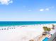 Scenic beach featuring white sand, blue water, and palm trees by a pool area at 13500 Gulf Blvd # 506, Madeira Beach, FL 33708