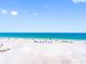 Expansive view of a white sand beach and clear blue ocean under a sunny sky at 13500 Gulf Blvd # 506, Madeira Beach, FL 33708