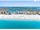 Beautiful view of white sand beach and turquoise ocean waters adjacent to picturesque waterfront condos at 13500 Gulf Blvd # 506, Madeira Beach, FL 33708