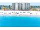 Aerial view of the beach featuring white sand and turquoise water at this beachside condo complex at 13500 Gulf Blvd # 506, Madeira Beach, FL 33708